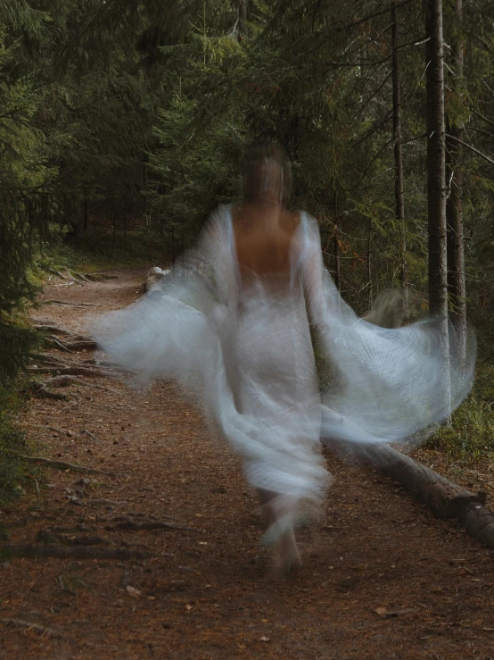 the blurry image is of a girl dressed in a white dress