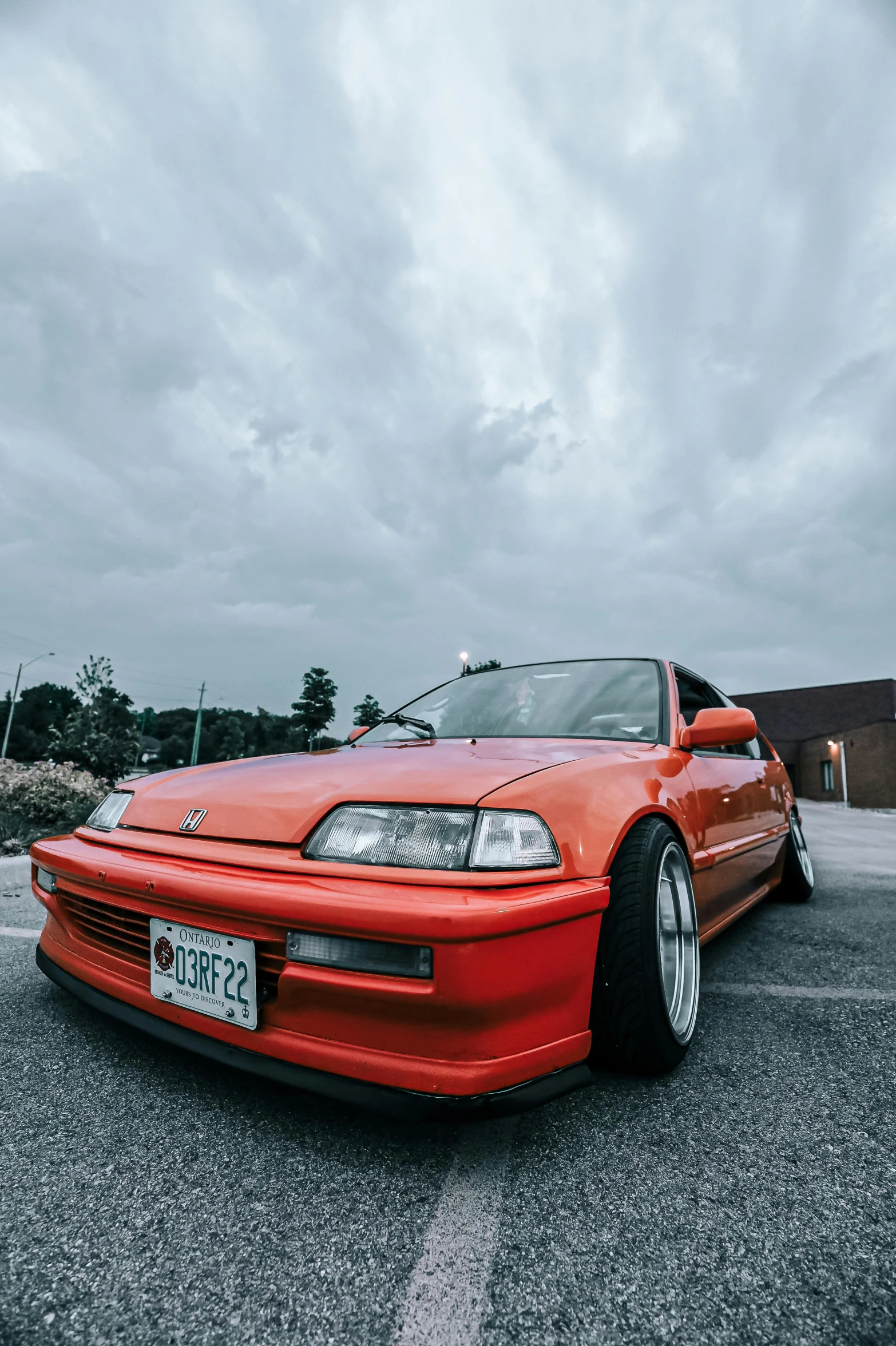 a red sports car parked in a parking lot