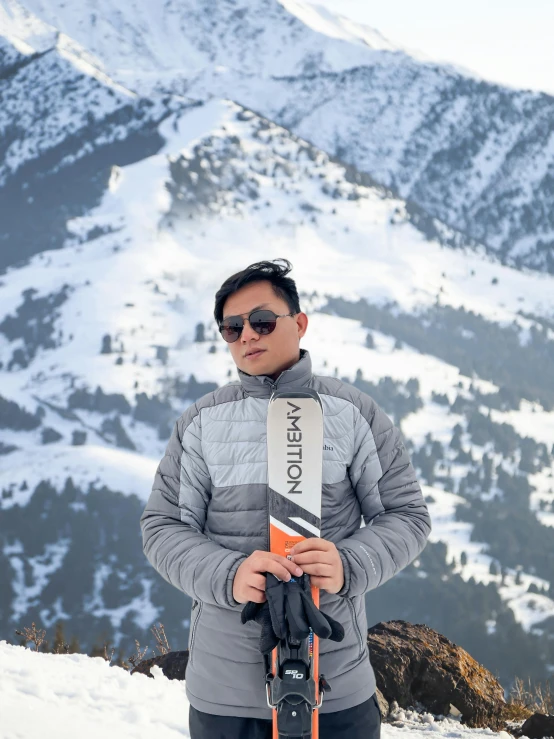 a young male snow skier wearing an ice jacket