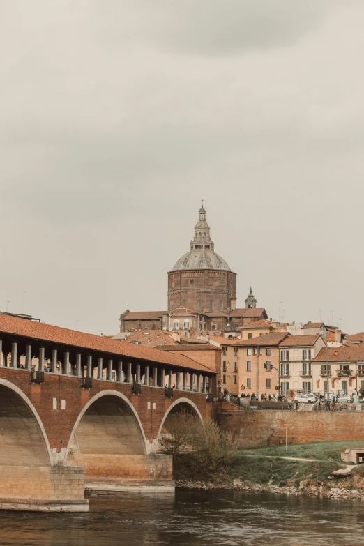 the bridge is over the river near the old building