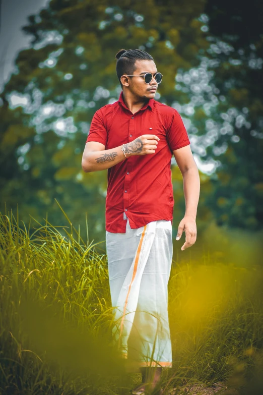 a man standing in the middle of tall grass