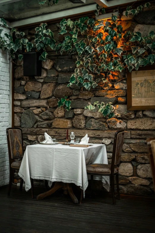a table with a white table cloth on it in a corner
