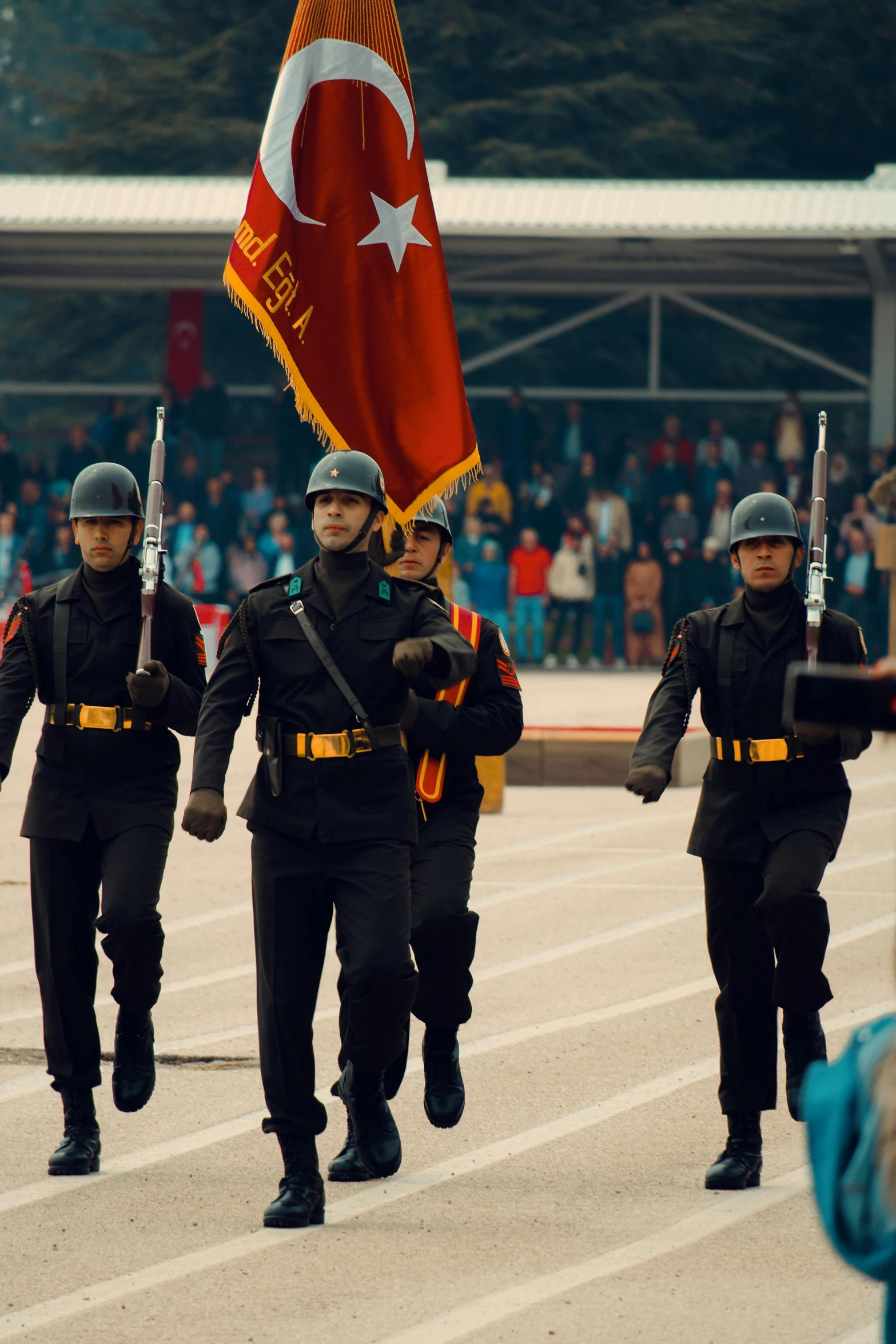 three people in military gear are marching