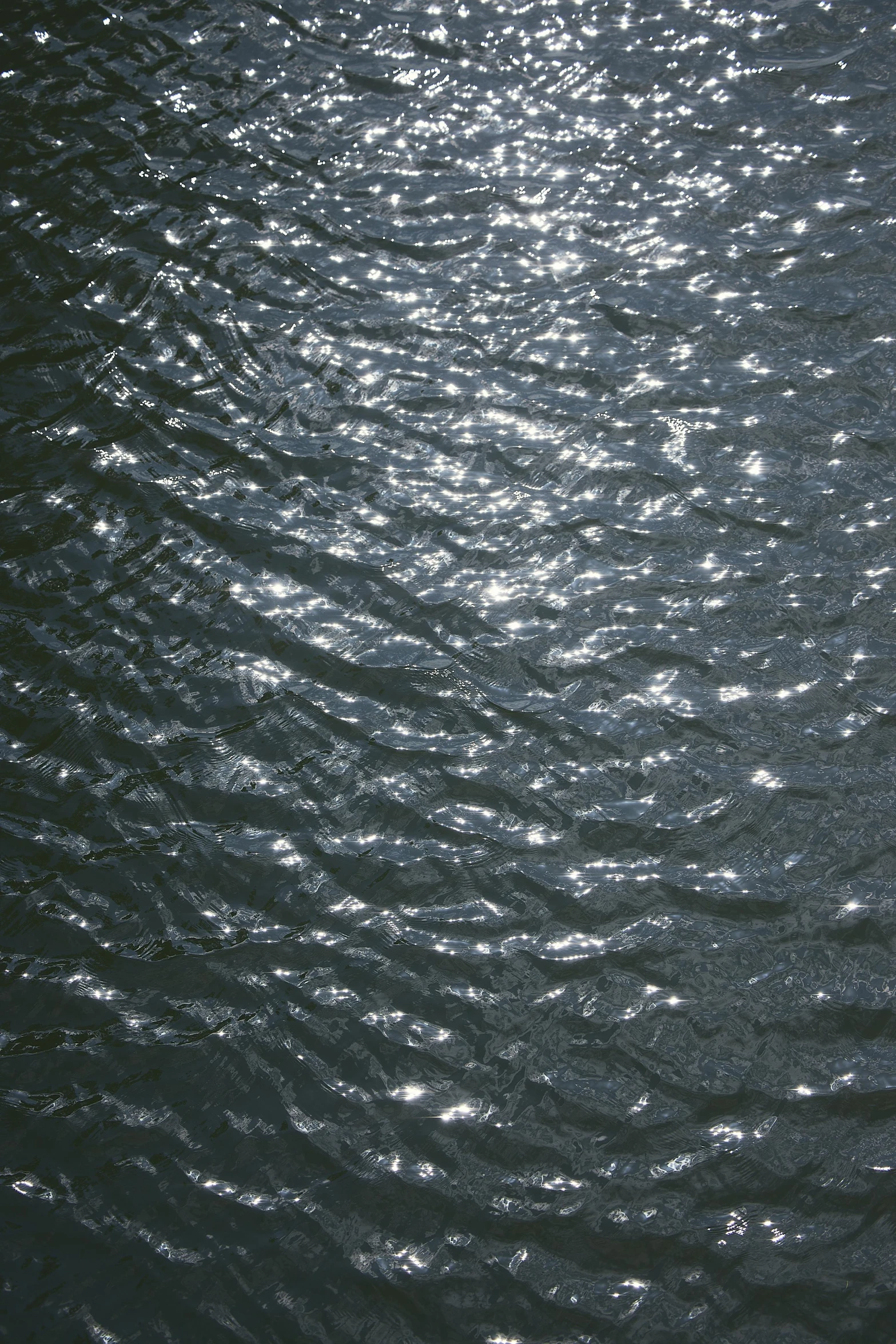 the sun shining in on water and creating a wave pattern