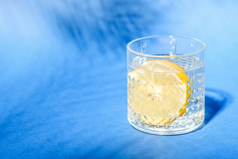 a lemon wedge that has fallen into a glass