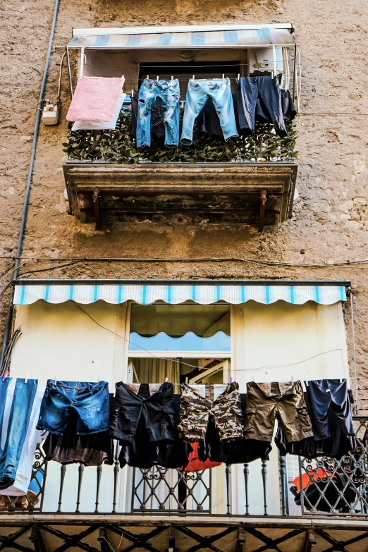 clothes hanging in the balcony of an apartment