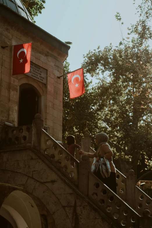 two people are on the stairs with flags