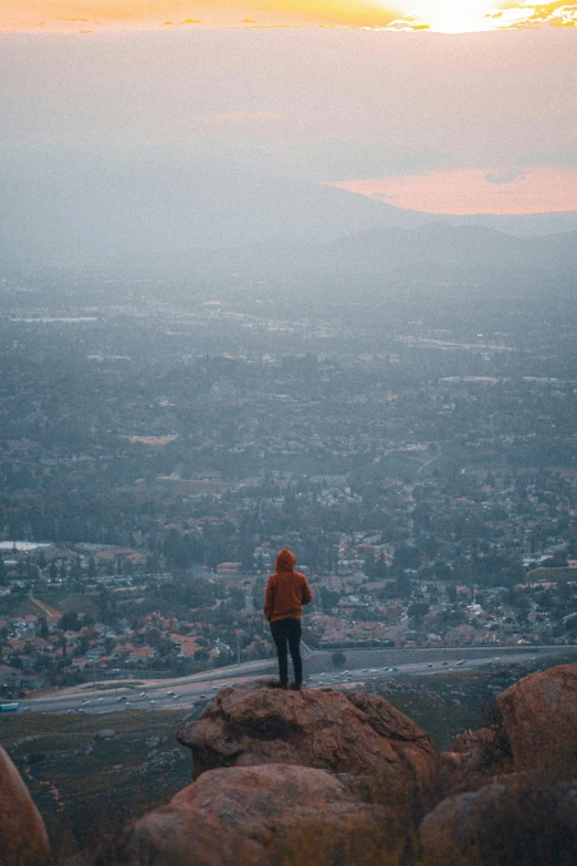 a person on top of a mountain looking down at the valley