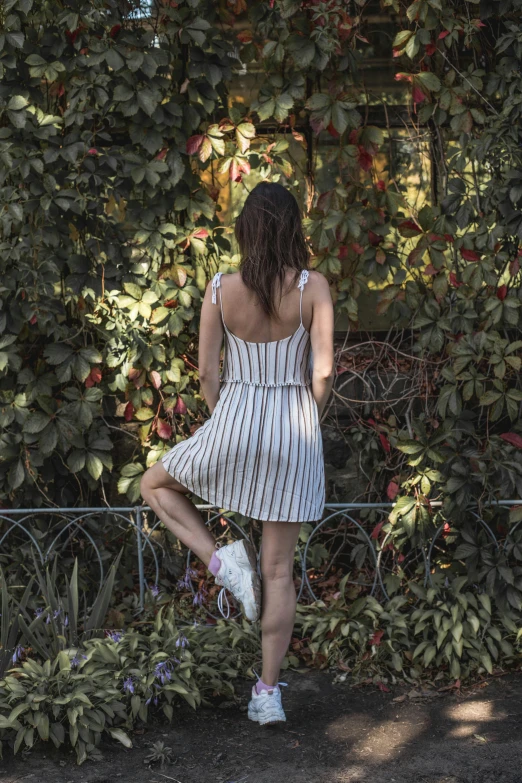 a woman is sitting on the ledge outside