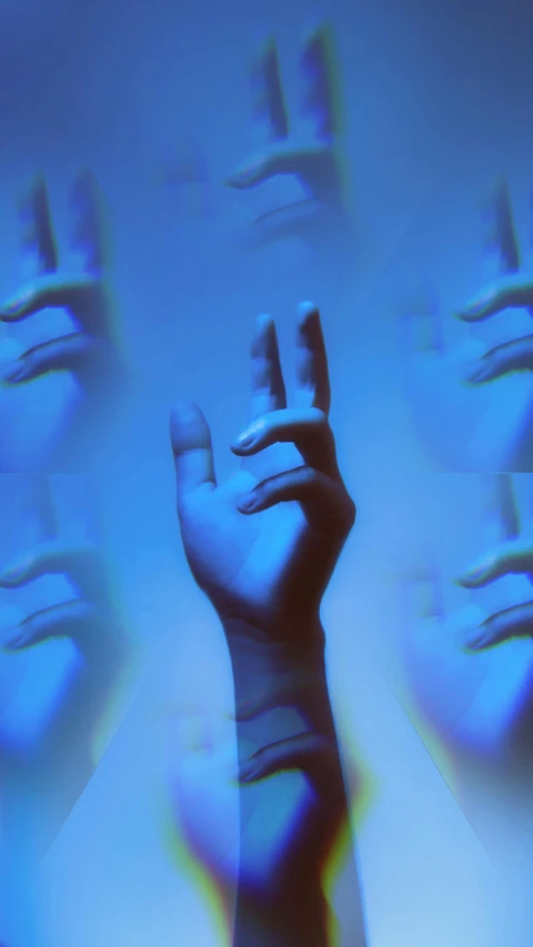 the hand is in front of a blue background with many different images