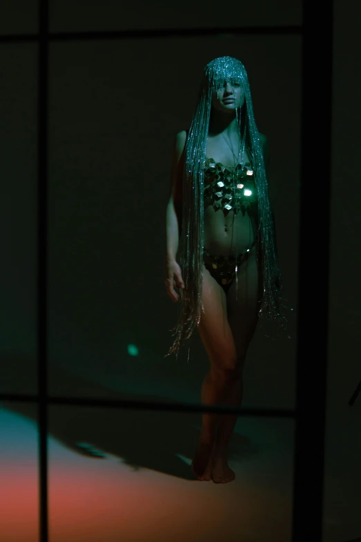 a mannequin dressed as a woman with green lights on her body