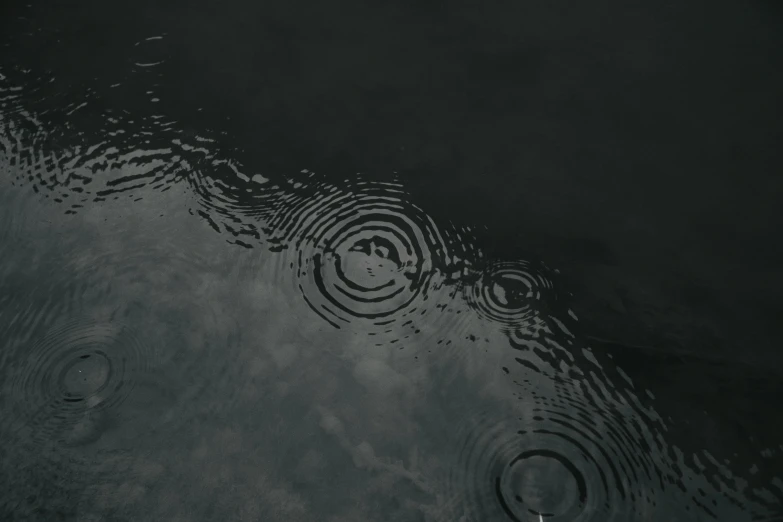 an umbrella floating in the water next to some waves