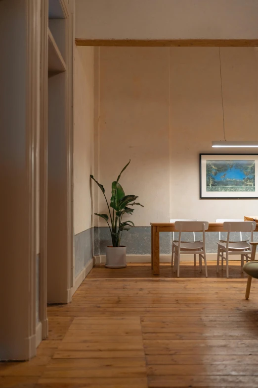 empty room with a bench and wooden floor with a chair in it