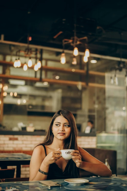 a woman sitting at a table with food