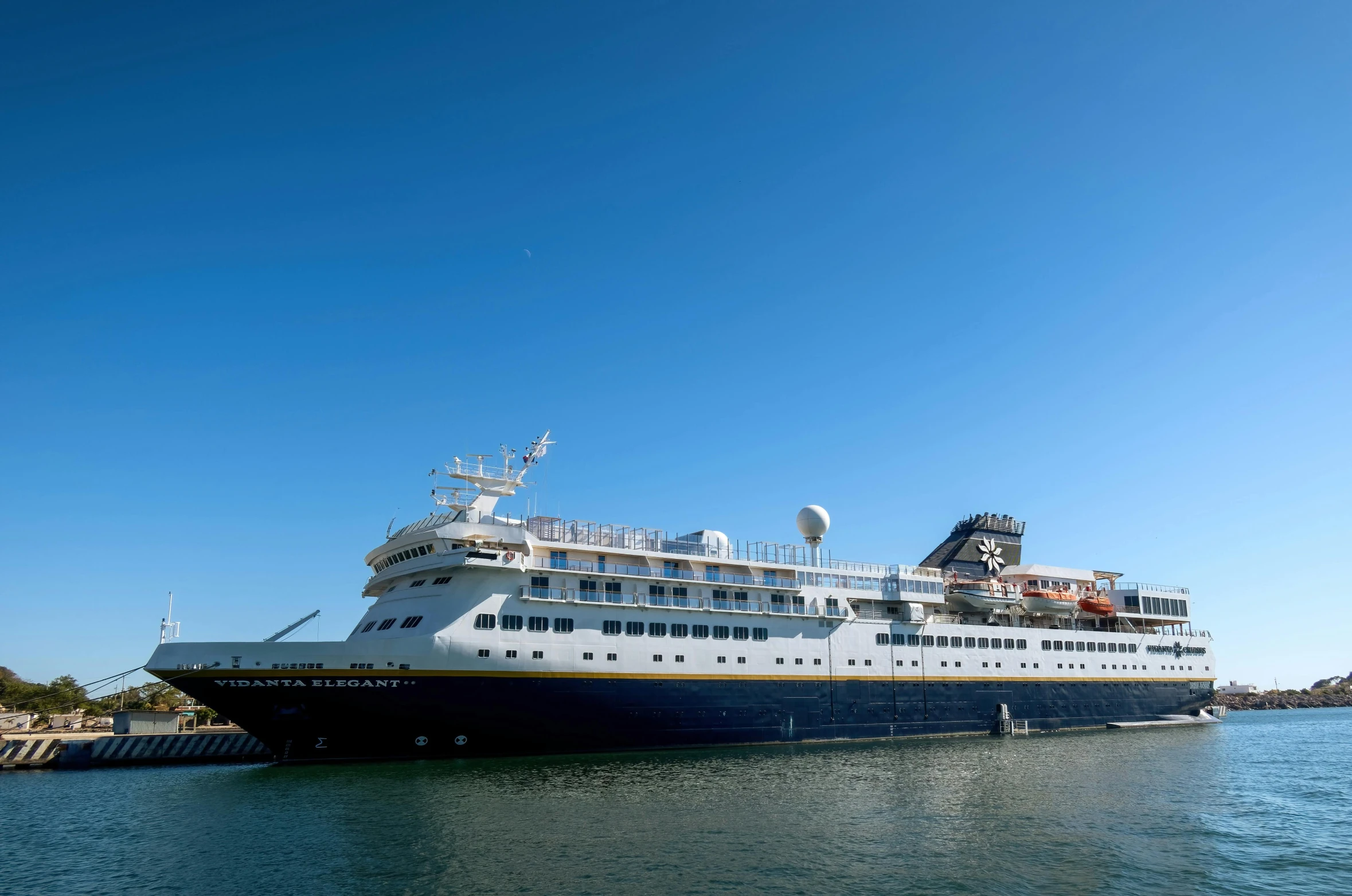 the large ship is docked at a small dock