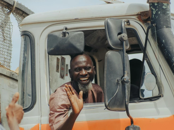 a person sitting in the driver's seat of a truck