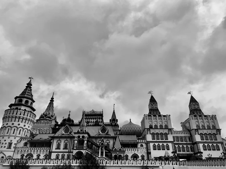 black and white pograph of a castle with clouds in the background