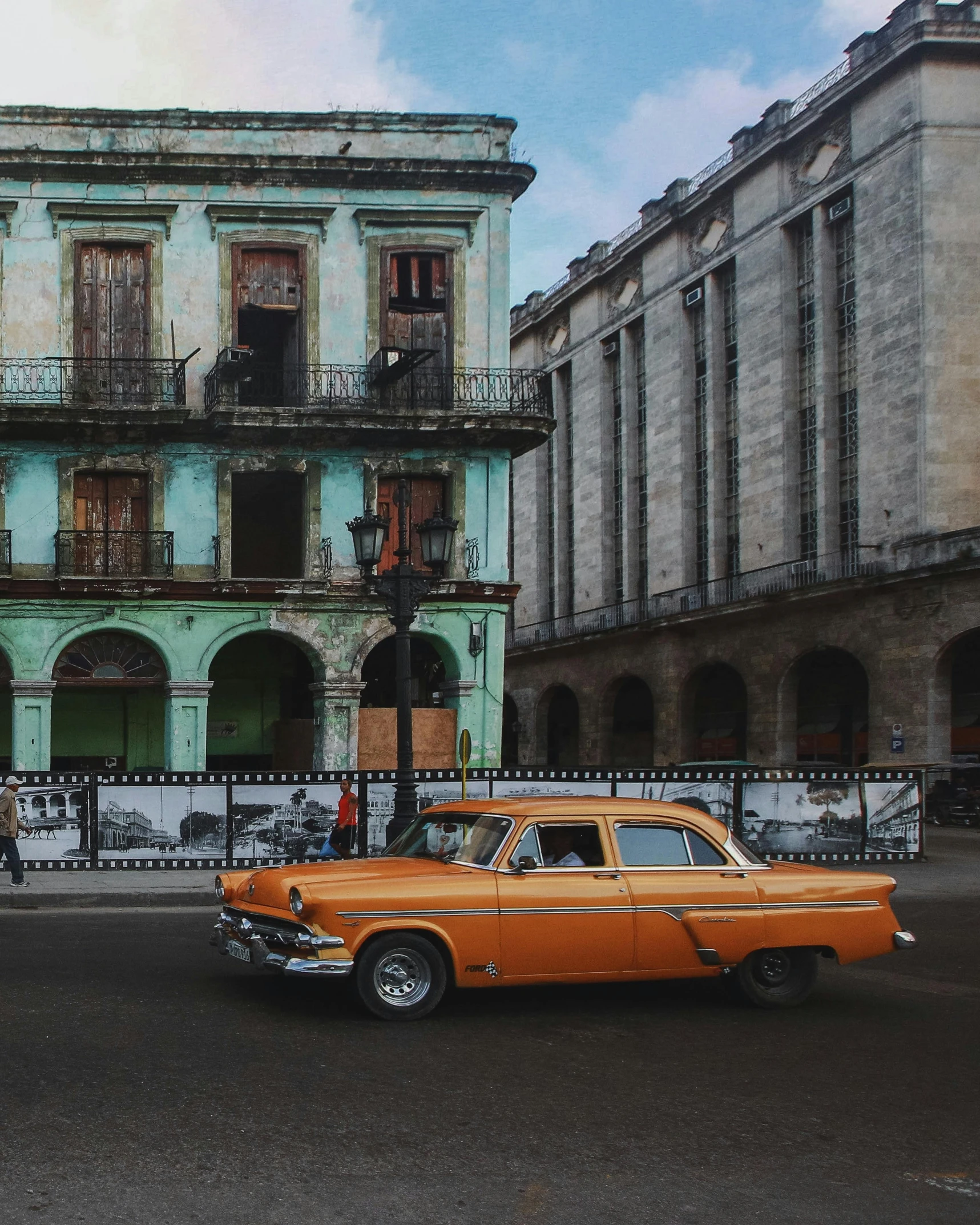 old car parked in front of a building