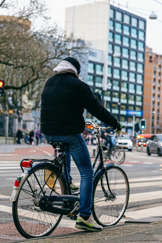 a man riding a bicycle down the middle of a street