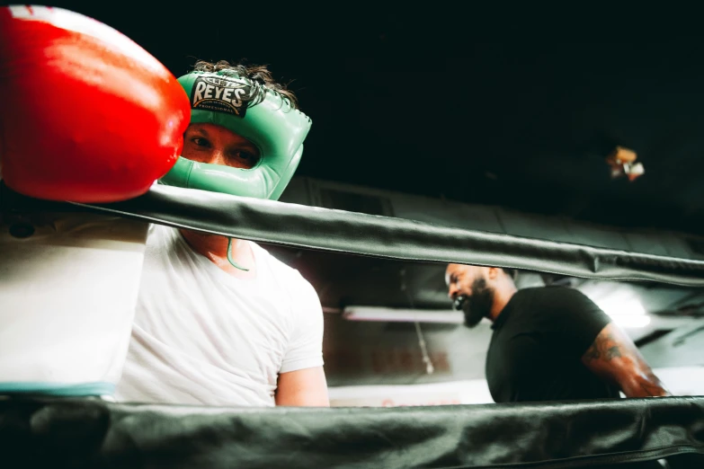 two boxers with their boxing gear on their heads