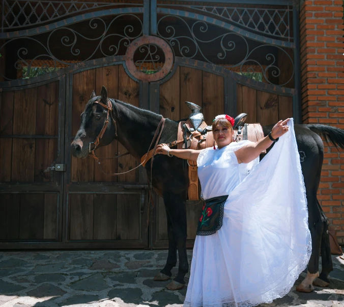 the young woman is posing with her dress on