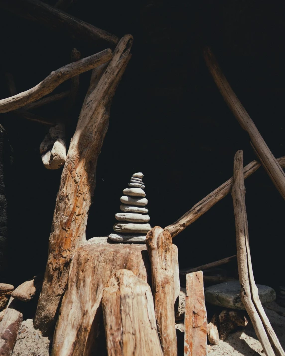 rock piles made from a tree trunk in a dark room