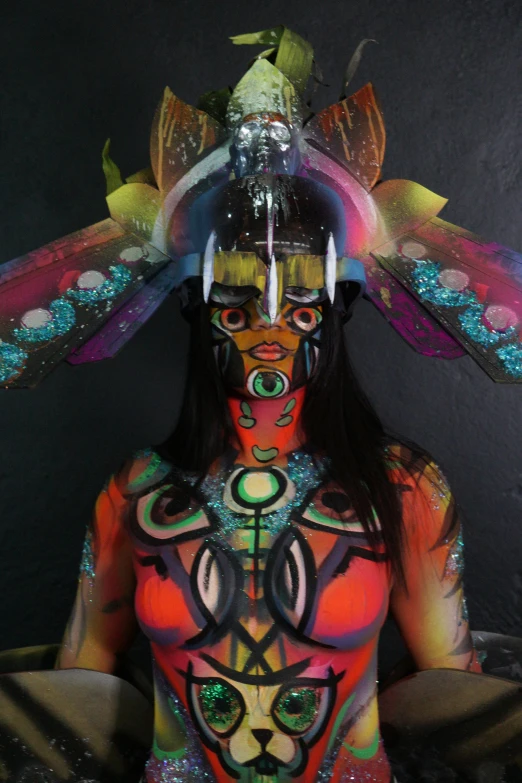 a woman with many colored paint on her body