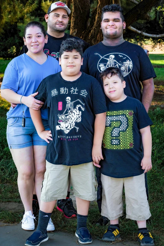 a family standing together, one with a small boy and one with a younger boy