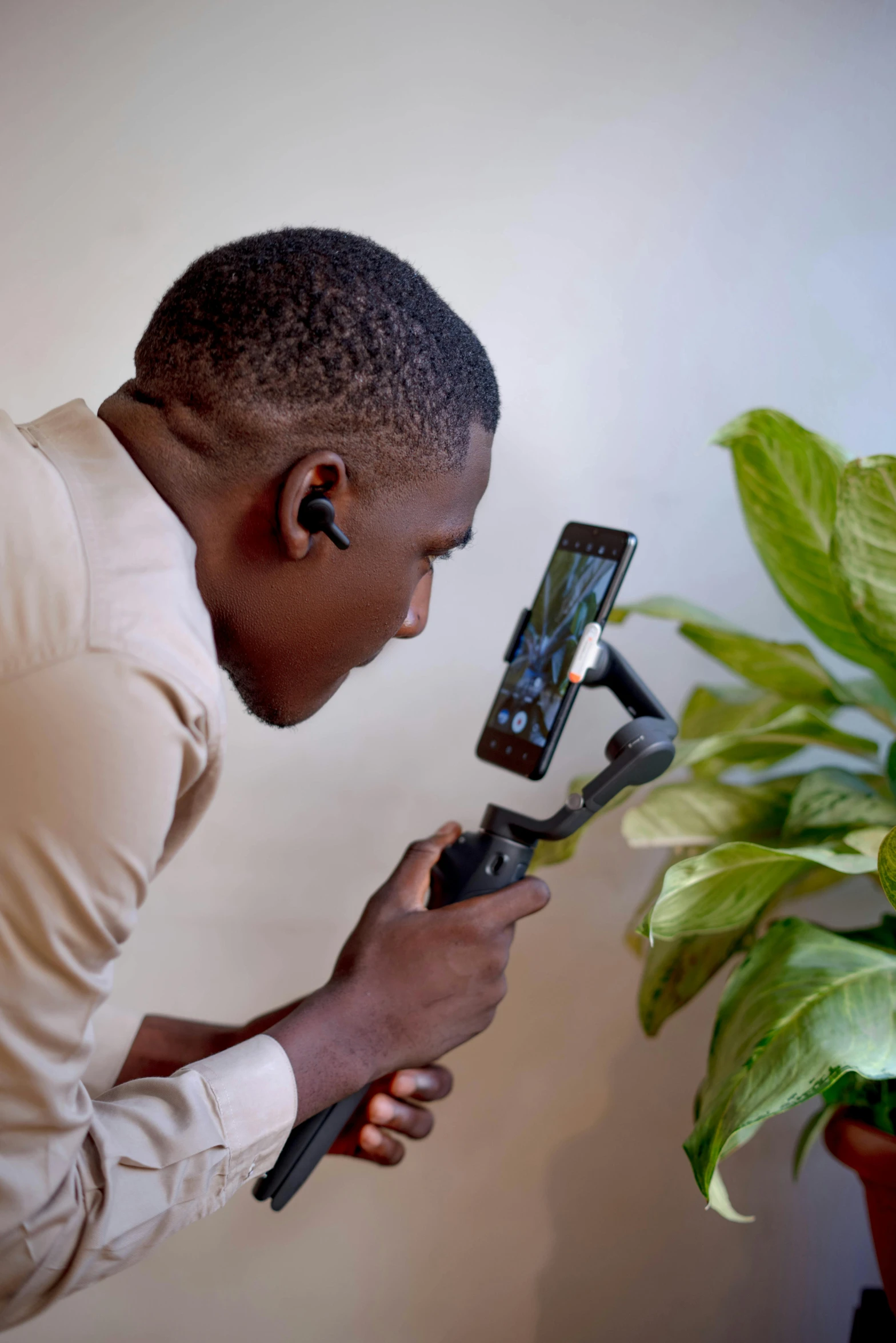 a man looking at an electronic device and holding it