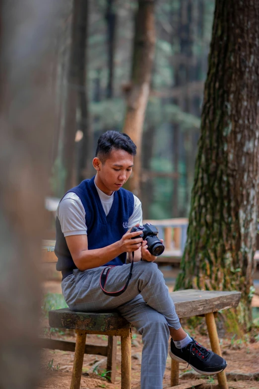 a person sitting on a bench in the woods