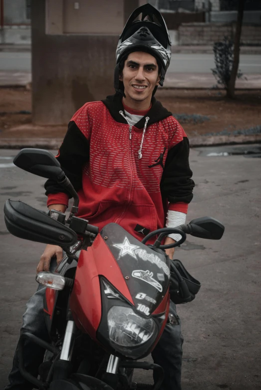 a man with a helmet on sitting on a motorcycle