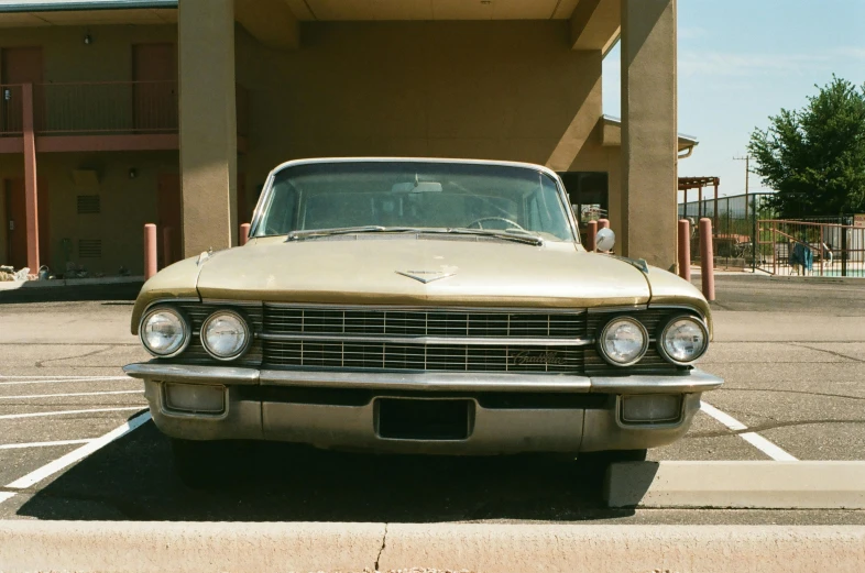 an old classic car parked in a parking lot