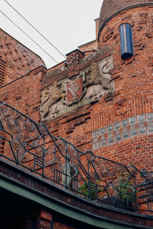 an artistic brick building with a balcony next to it