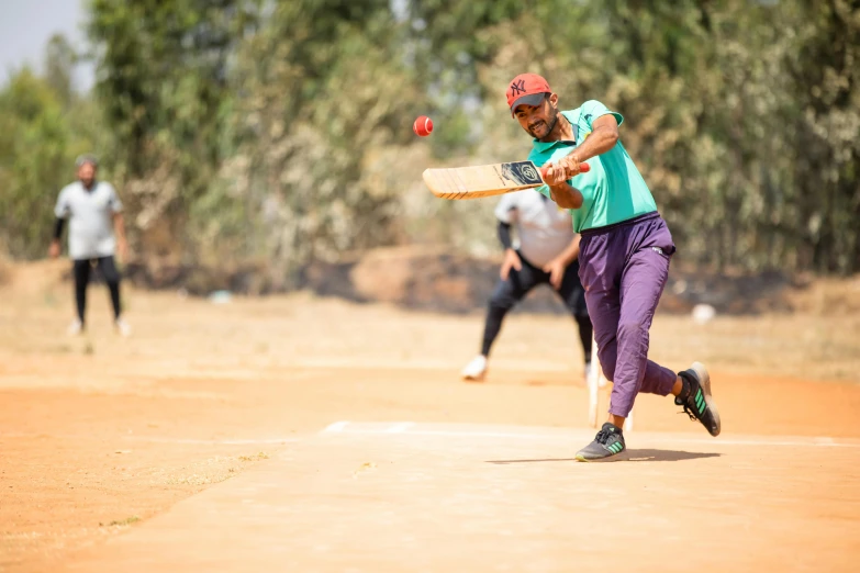 an indian female is playing softball while another looks on