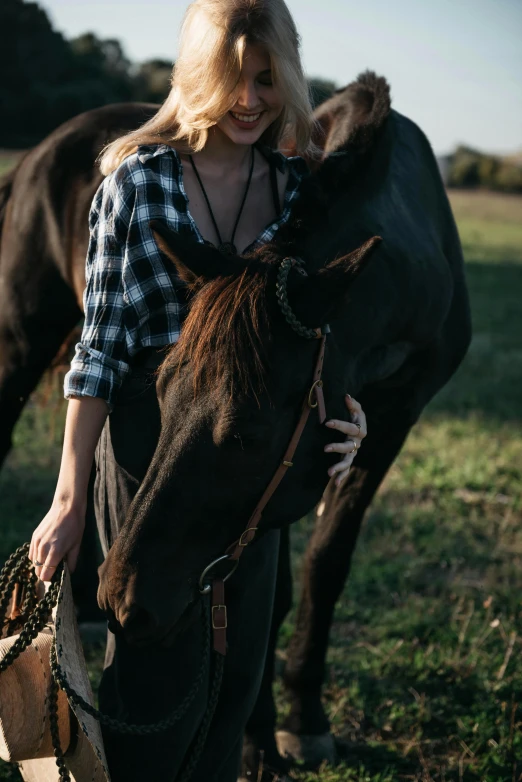 a young woman walking with her horse on a sunny day