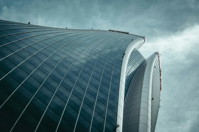 a blue building with white lines and a very tall structure