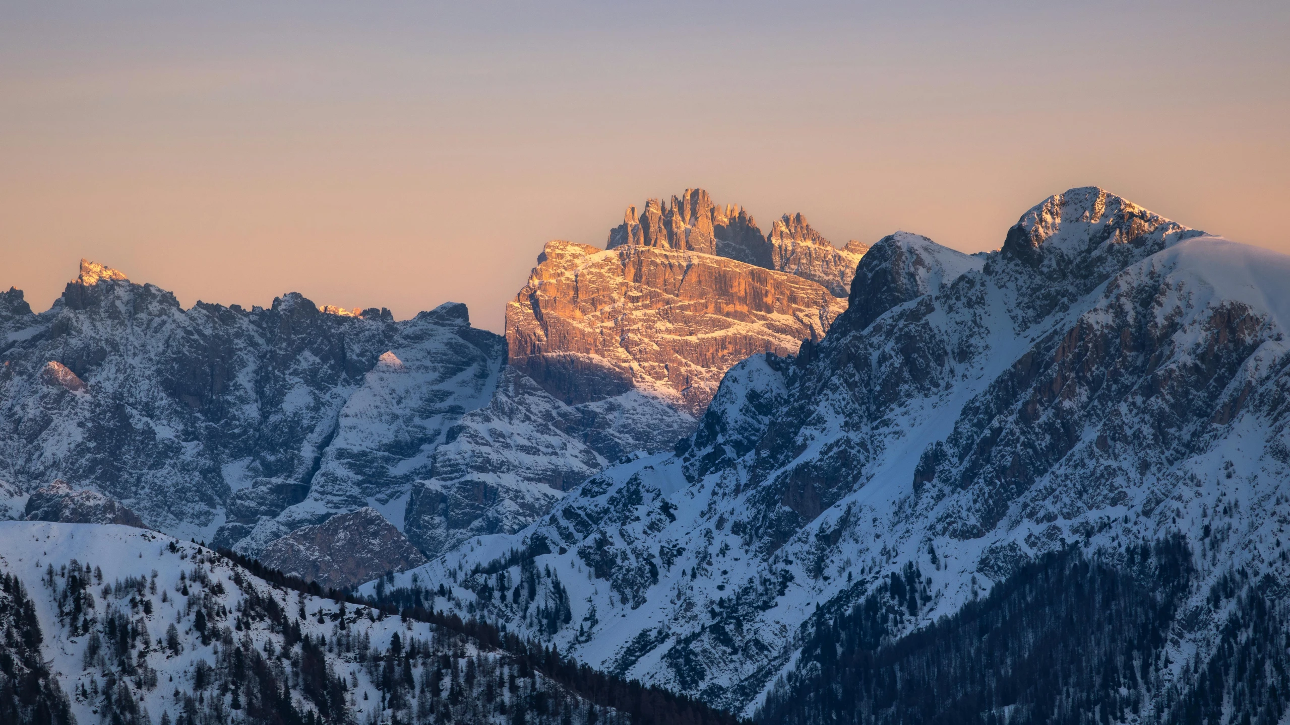 a picture of a snow capped mountain with a sky background