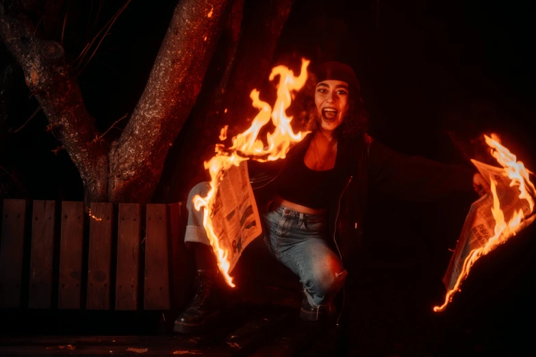 man in black shirt and jean skirt with fire dancing