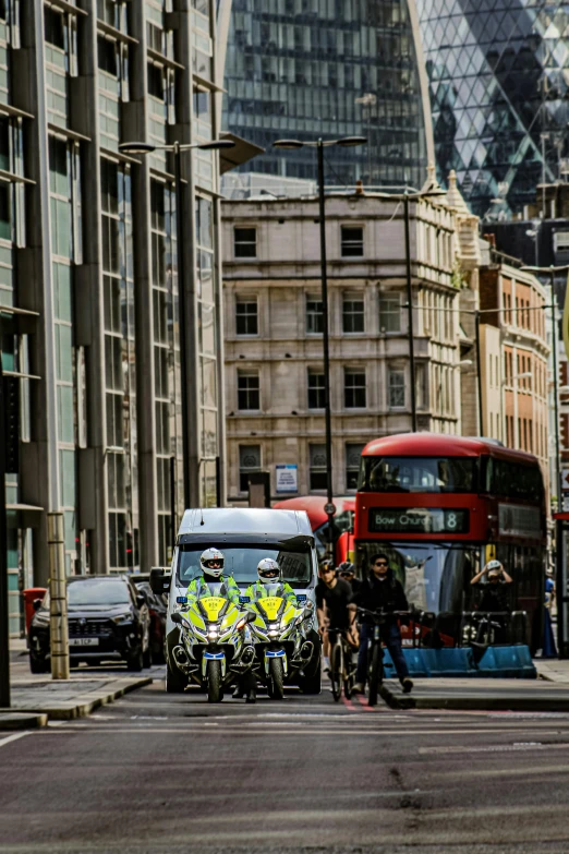 the double decker bus is going through the city