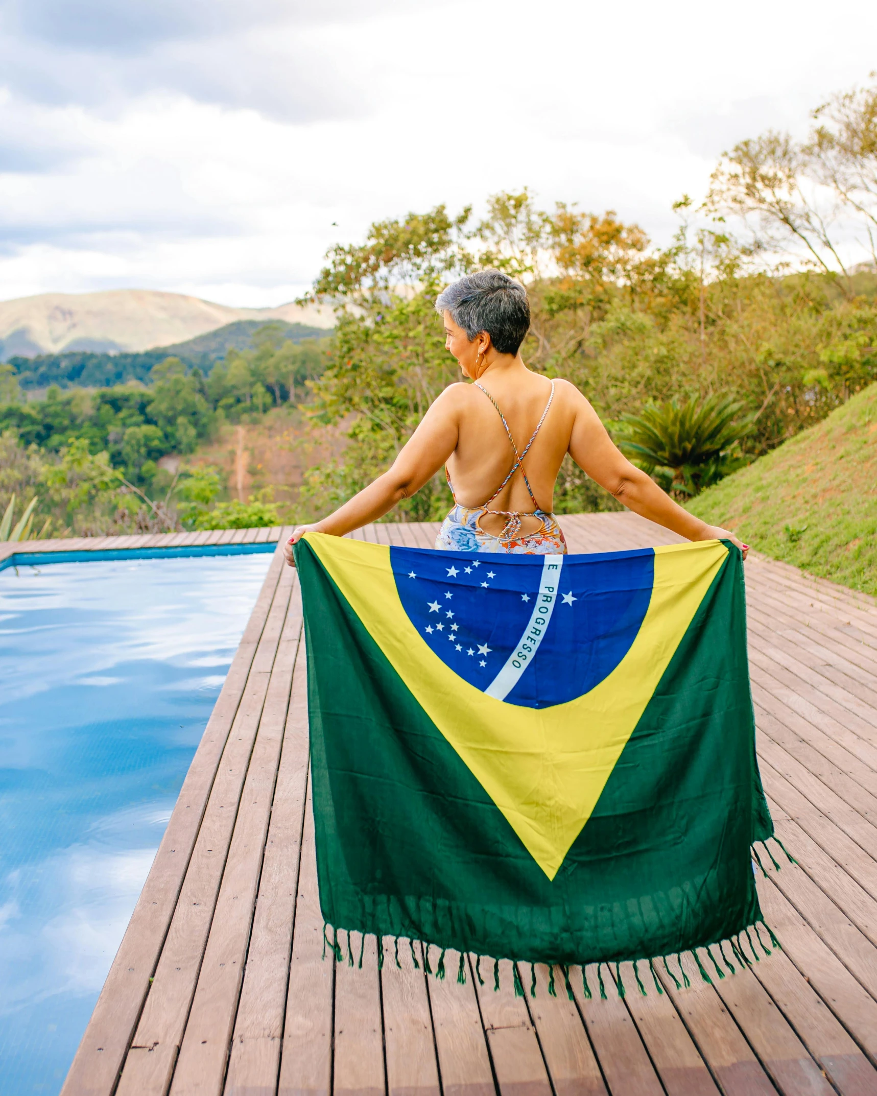 a person with a large flag near a pool