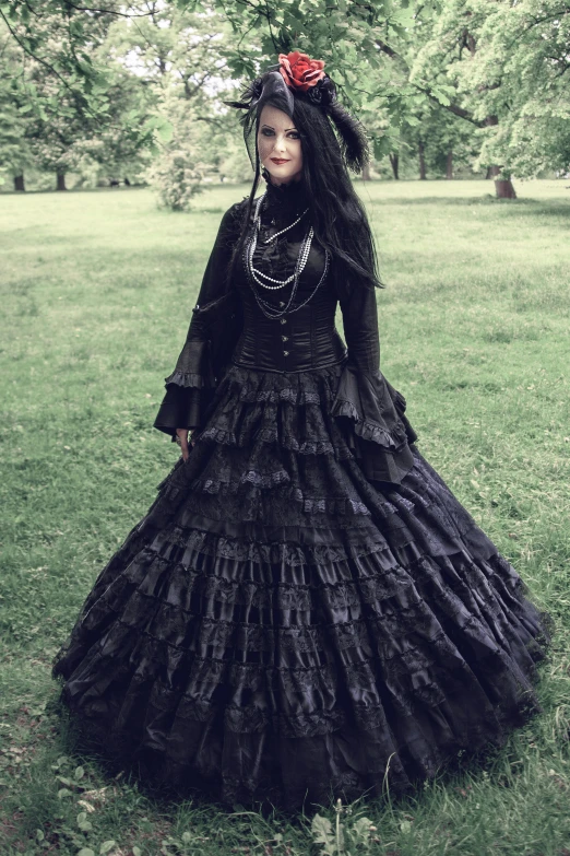 a lady dressed up in black dress on grass