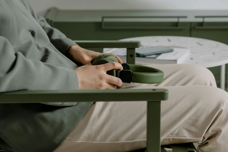 a man in a green shirt is sitting at a table