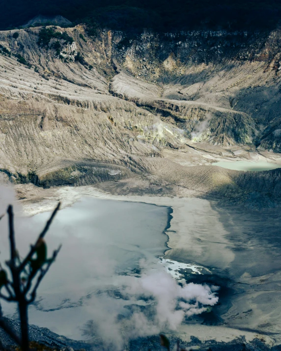 a lake surrounded by dry grass and dirt