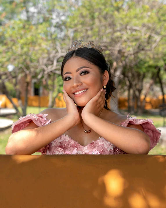 a beautiful woman posing for a po with her arms resting on her face