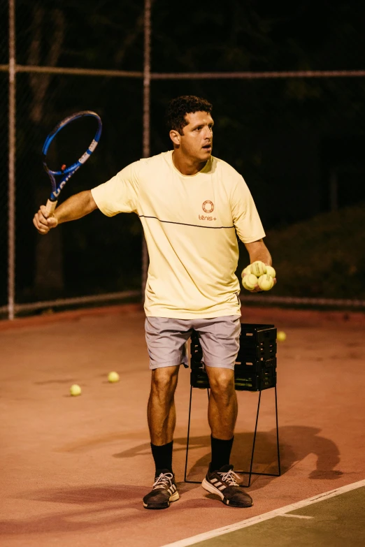 a tennis player stands with a racket and ball on a court