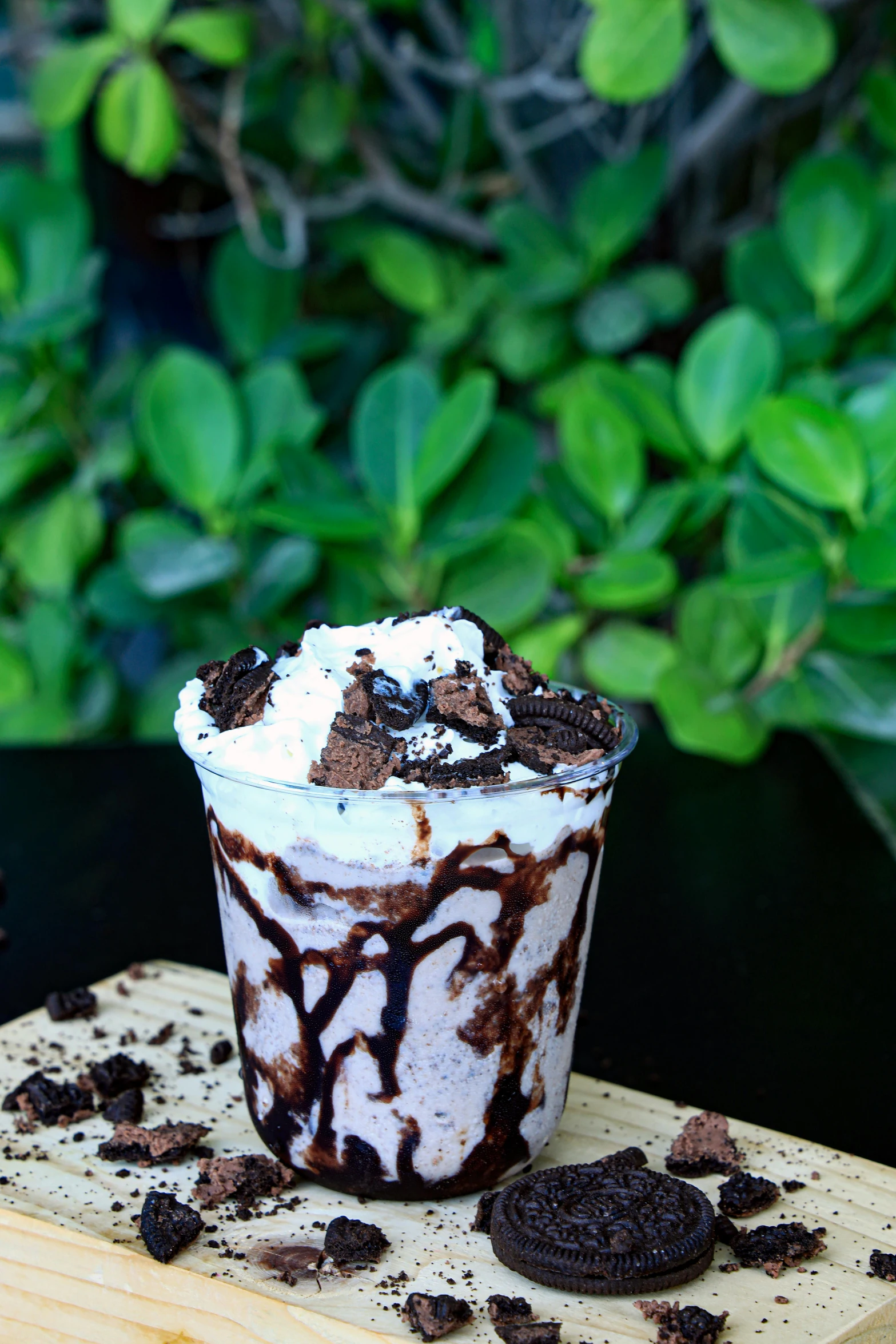 an oreo flavor ice cream sundae is topped with cookie chunks