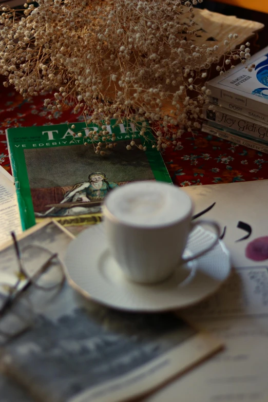 a cup of coffee and some magazines