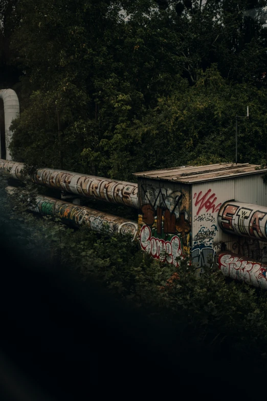 a train track with many pieces of graffiti on it