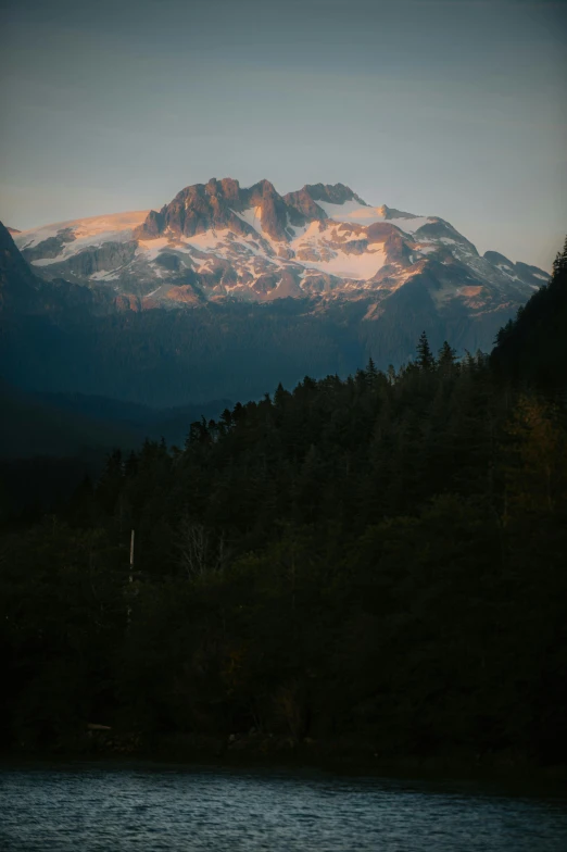 a mountain is shown with trees and mountains in the background