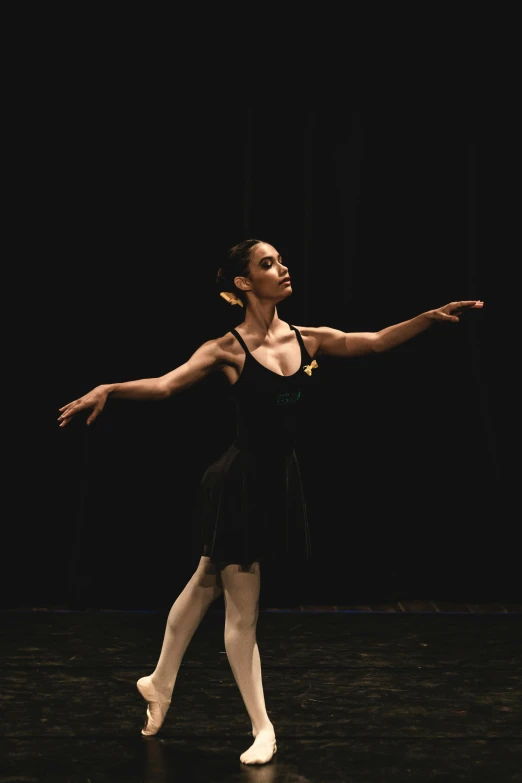 a ballerina is standing with her arms outstretched